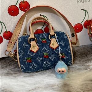 Miniature Vuitton Murakami cherry speedys with baby labubu charms